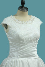 Load image into Gallery viewer, 2023 Scoop Cap Sleeve Wedding Dresses A Line Satin With Ruffles And Applique Sweep Train